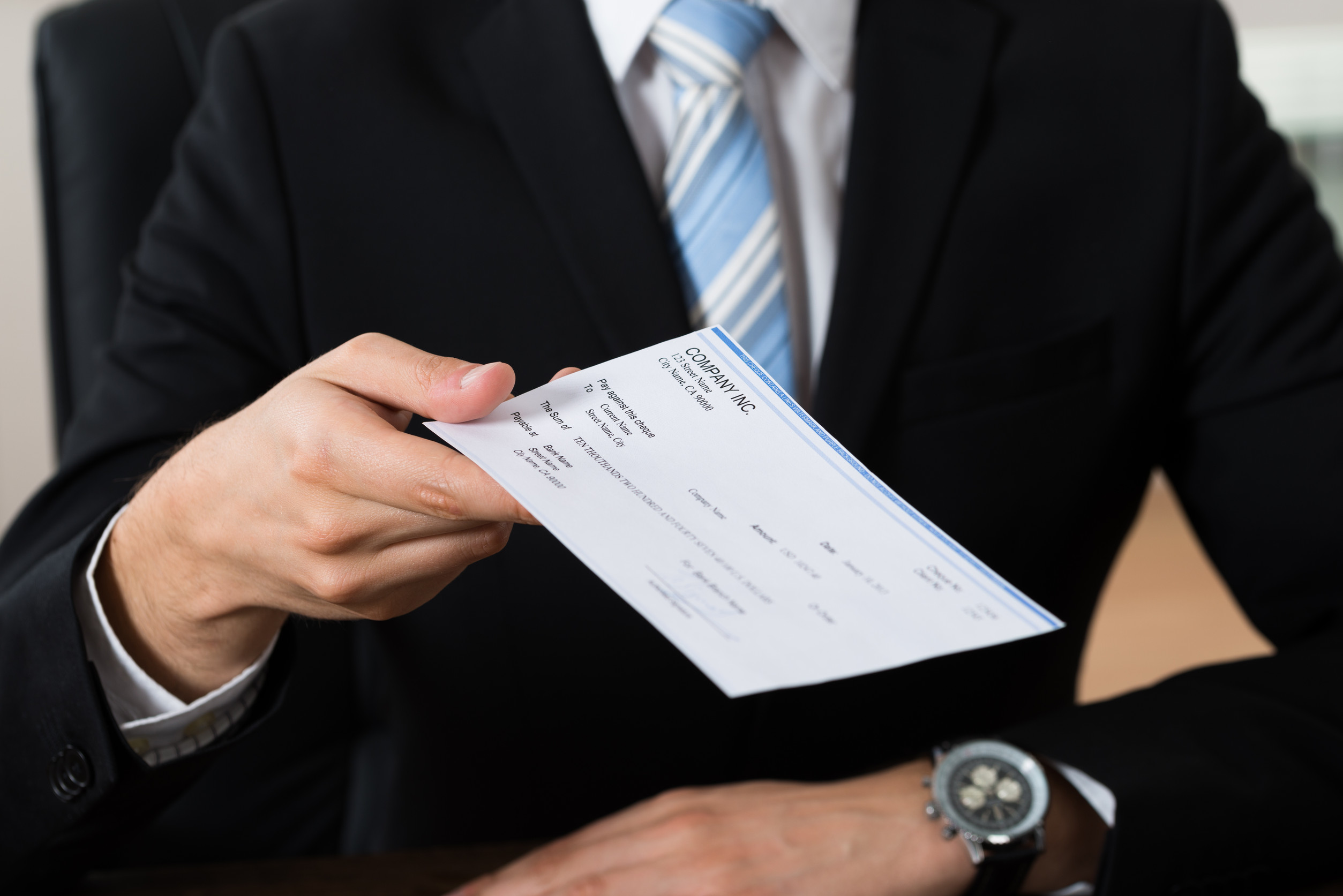 Businessman Giving Cheque